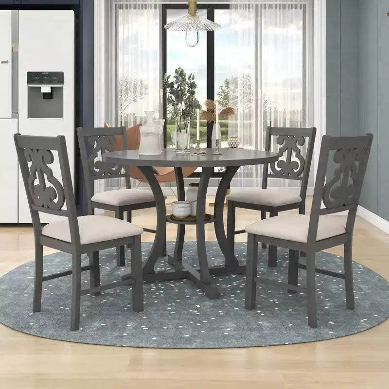 Set da pranzo in legno da 5 pezzi, con tavolo rotondo, gambe dalla forma particolare e sedia con schienale traforato dal design raffinato, per la cucina